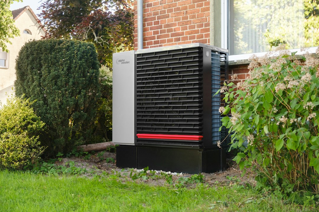 An air-source heat pump outside a brick house